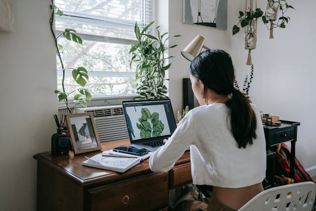 Woman in her office behind a laptop.