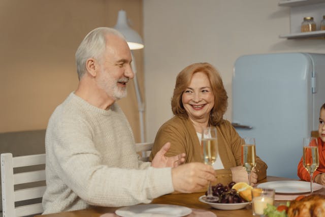 Family Eating Dinner by the Table speaking their partner's native language